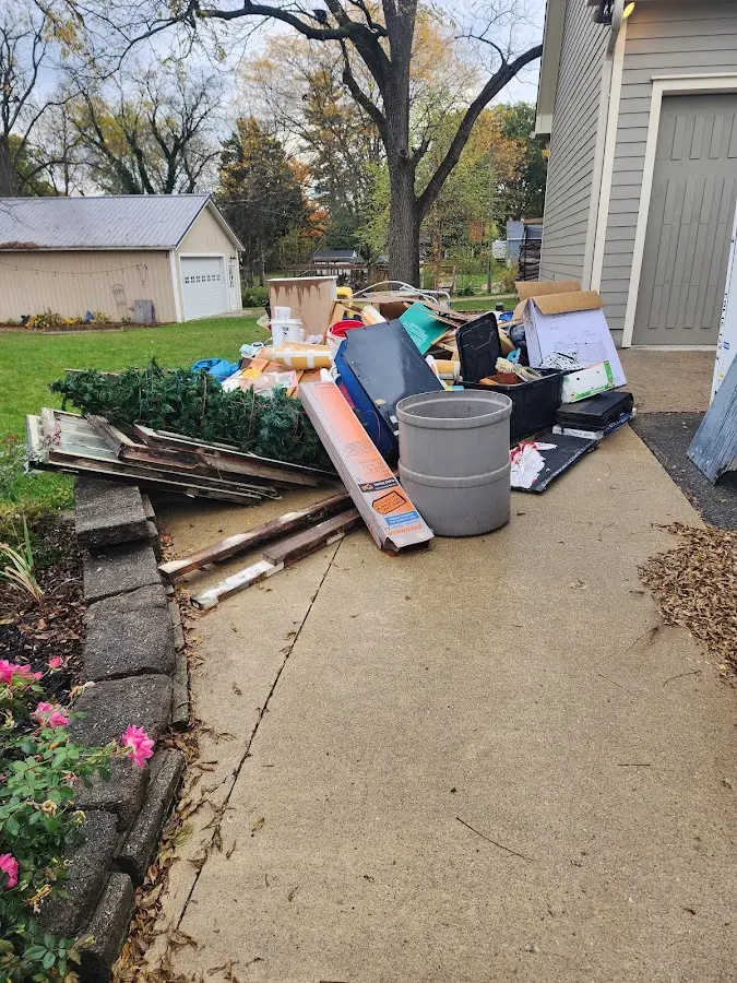 Dumpster being loaded with debris for 12 Yard Dumpster Rental in Mount Ephraim